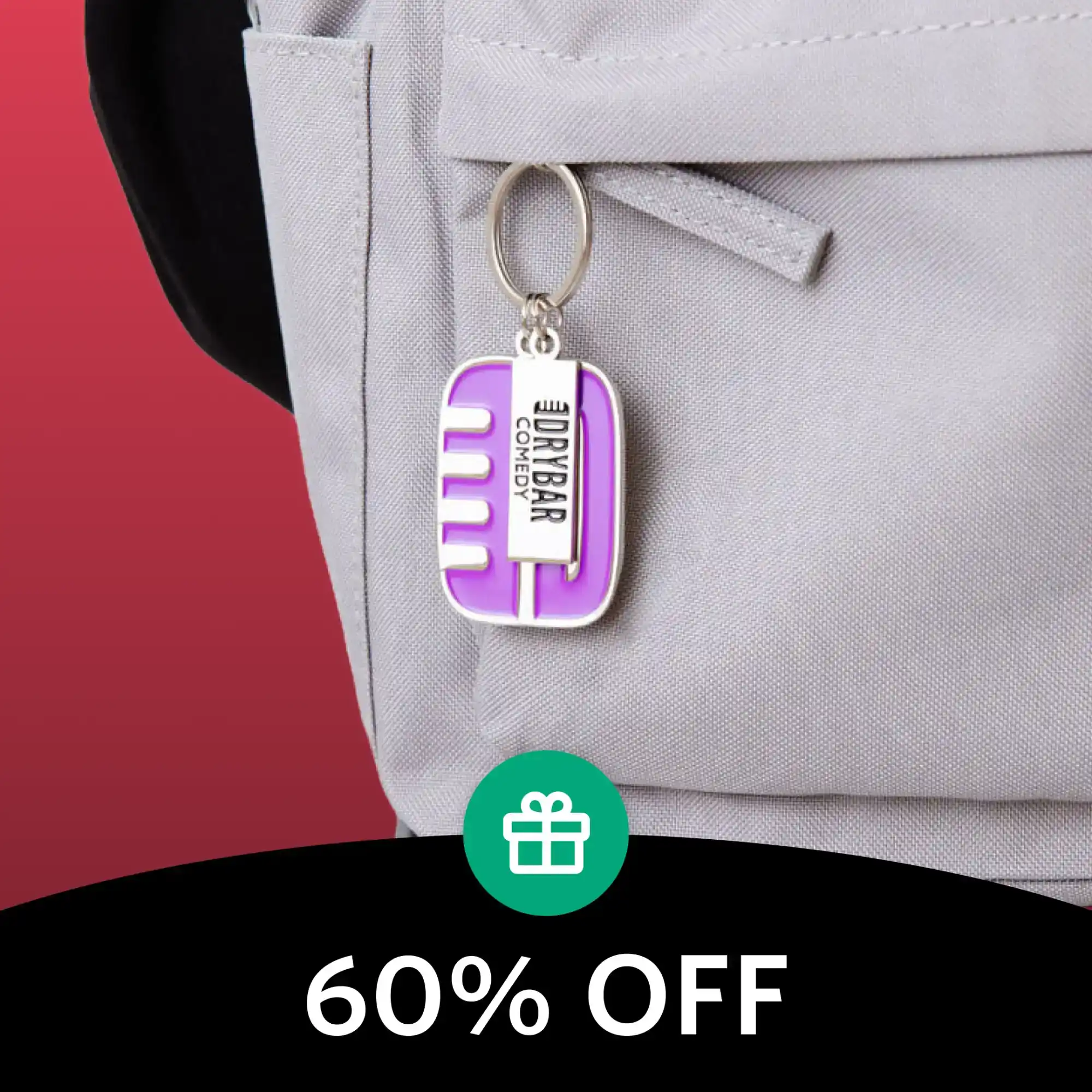 Purple and white keychain charm attached to a light gray backpack.